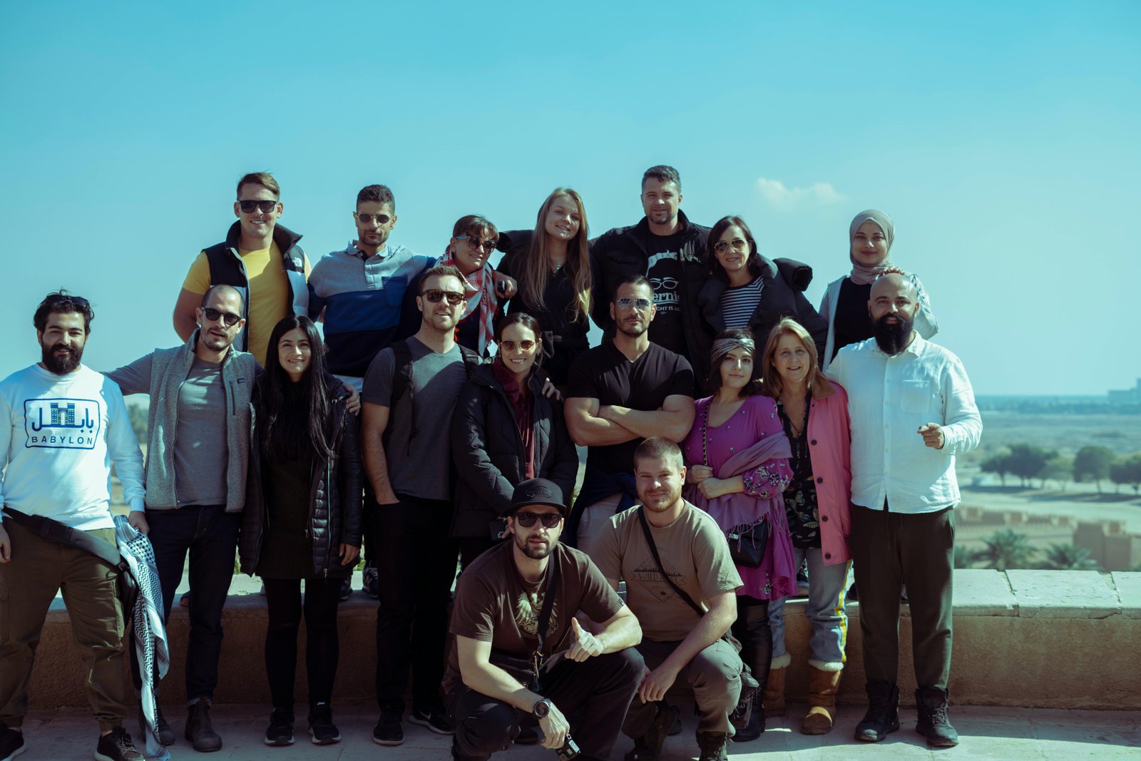 Diverse group of travelers celebrating at a scenic overlook